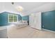 Bright bedroom with blue accent walls and an abundance of natural light at 701 Robert Ln, Canton, GA 30114