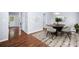 Bright dining room featuring hardwood floors, rug, and modern furnishings at 701 Robert Ln, Canton, GA 30114