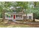 Charming two-story home featuring a welcoming front porch with a bright red door at 701 Robert Ln, Canton, GA 30114
