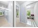 Bright hallway leads to carpeted bedrooms, showing natural light and access to laundry room at 701 Robert Ln, Canton, GA 30114