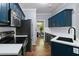 Modern kitchen featuring dark cabinets, stainless steel appliances, and white countertops at 701 Robert Ln, Canton, GA 30114