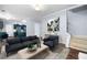 Inviting living room with dark sofa, stairs, and open view to the kitchen at 701 Robert Ln, Canton, GA 30114