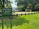 A playground at Field's Landing with a sign that displays information about fees and passes at 701 Robert Ln, Canton, GA 30114