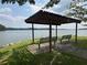 A scenic view of the lake with benches and a covered area at 701 Robert Ln, Canton, GA 30114