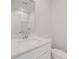 A half-bathroom featuring a white vanity, toilet, and a large mirror reflecting ample lighting at 777 Ruddy Drive (Lot20), Grayson, GA 30017