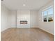 Bright living room with hardwood floors, white walls, modern fireplace, and a large window at 777 Ruddy Drive (Lot20), Grayson, GA 30017