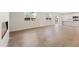 Open living area with hardwood floors, fireplace, white walls, windows, and access to the kitchen at 777 Ruddy Drive (Lot20), Grayson, GA 30017