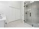 Modern bathroom featuring a frameless glass shower, double closet, and sleek vanity at 2863 Landing Dr, Marietta, GA 30066