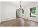 Dining room with hardwood floors, crown molding, two large windows, and modern lighting at 2863 Landing Dr, Marietta, GA 30066