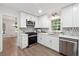 Updated kitchen features white cabinets, stainless steel appliances, and a stylish backsplash at 2863 Landing Dr, Marietta, GA 30066