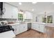 Updated kitchen with white cabinets, stainless steel appliances, and hardwood floors at 2863 Landing Dr, Marietta, GA 30066