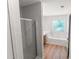 This modern bathroom features wood-look flooring, a tub, and a glass-enclosed shower at 3134 Imperial Sw Cir, Atlanta, GA 30311