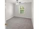 Bedroom featuring carpet and ceiling fan, with window letting in natural light at 3134 Imperial Sw Cir, Atlanta, GA 30311