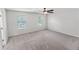 This bedroom features neutral carpeting, two windows, and a ceiling fan at 3134 Imperial Sw Cir, Atlanta, GA 30311
