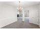 Open dining area featuring modern lighting, neutral paint, and carpeted floors, connecting to the main living space at 3134 Imperial Sw Cir, Atlanta, GA 30311