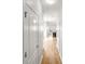 Clean hallway leading to the kitchen with hardwood flooring, white walls, and natural light, creating a bright and open feel at 3134 Imperial Sw Cir, Atlanta, GA 30311