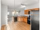 Bright kitchen with wood cabinetry, granite countertops, and stainless steel appliances adjacent to the living area at 3134 Imperial Sw Cir, Atlanta, GA 30311