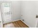 Bright laundry room with wood-look flooring and a door to the backyard at 3134 Imperial Sw Cir, Atlanta, GA 30311