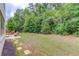Large backyard with mature trees, patio and landscaping at 4241 Summer Breeze Way, Buford, GA 30518