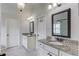 Bathroom featuring double vanity with granite countertop, tile floors, and framed mirrors at 4241 Summer Breeze Way, Buford, GA 30518