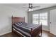 Bedroom with hardwood floors, ceiling fan, and large window with blinds at 4241 Summer Breeze Way, Buford, GA 30518