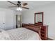 Bedroom boasts ceiling fan, dresser and dark wood floors at 4241 Summer Breeze Way, Buford, GA 30518