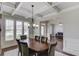 The dining room boasts coffered ceilings, ample natural light, and hardwood floors at 4241 Summer Breeze Way, Buford, GA 30518