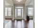 Welcoming foyer features hardwood floors and a view into the living spaces at 4241 Summer Breeze Way, Buford, GA 30518
