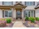 Charming front porch welcomes you with stone accents and manicured landscaping at 4241 Summer Breeze Way, Buford, GA 30518