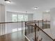 Upstairs hallway with wood handrails, wood floors and white walls and trim at 4241 Summer Breeze Way, Buford, GA 30518