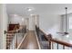 Hallway overlooking living room with hardwood floors and decorative wood and iron railing at 4241 Summer Breeze Way, Buford, GA 30518