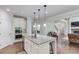 Open kitchen featuring granite counters, an island with a sink, and bar stool seating at 4241 Summer Breeze Way, Buford, GA 30518