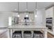 Bright kitchen with granite counters, island with bar stools, and stainless appliances at 4241 Summer Breeze Way, Buford, GA 30518