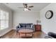Cozy living room with hardwood floors, a ceiling fan, and a neutral color palette at 4241 Summer Breeze Way, Buford, GA 30518