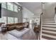 Bright, open living room features tall ceilings, hardwood floors and large windows at 4241 Summer Breeze Way, Buford, GA 30518