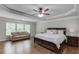 Spacious main bedroom featuring trey ceiling, sitting area, hardwood floors and natural light at 4241 Summer Breeze Way, Buford, GA 30518