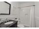 Modern bathroom with black vanity, bathtub and shower with a scallop tile backsplash at 636 Cameron Street Se St, Atlanta, GA 30312