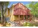 A home's back exterior showcases a wooden deck with lattice and access to the basement level at 636 Cameron Street Se St, Atlanta, GA 30312
