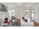 Bright living room featuring a fireplace, hardwood floors, a decorative front door, and stylish decor at 636 Cameron Street Se St, Atlanta, GA 30312