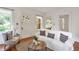 Bright living room featuring hardwood floors, a decorative front door, and a comfortable white sofa at 636 Cameron Street Se St, Atlanta, GA 30312