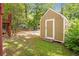 A backyard shed with a white door and window is framed by a grassy area at 636 Cameron Street Se St, Atlanta, GA 30312