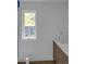 Well-lit bathroom area with wood cabinets, white countertops, and a window at 998 Lookout Nw Ave, Atlanta, GA 30318