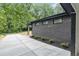 Side view of home exterior, showcasing brickwork, windows, landscaping, and a concrete driveway at 998 Lookout Nw Ave, Atlanta, GA 30318