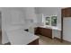 Well-lit kitchen featuring wood cabinets, white countertops, modern sink, and a window at 998 Lookout Nw Ave, Atlanta, GA 30318