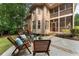 Exterior backyard with pool, patio, outdoor seating, and stairs to the screened porch at 10135 High Falls Pointe, Johns Creek, GA 30022