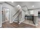 Basement features a staircase and kitchenette area with dark cabinets and a small refrigerator at 10135 High Falls Pointe, Johns Creek, GA 30022