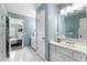 Beautiful bathroom with blue walls, white tile floors, and double doors leading to the bedroom at 10135 High Falls Pointe, Johns Creek, GA 30022
