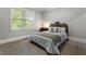 Comfortable bedroom with a queen-size bed, neutral colors, and a view of the outdoors at 10135 High Falls Pointe, Johns Creek, GA 30022
