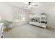 Bright bedroom with white walls, a bunk bed, and large windows providing plenty of natural light at 10135 High Falls Pointe, Johns Creek, GA 30022