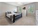 Cozy bedroom featuring neutral paint, carpet, and large windows that provide natural light at 10135 High Falls Pointe, Johns Creek, GA 30022